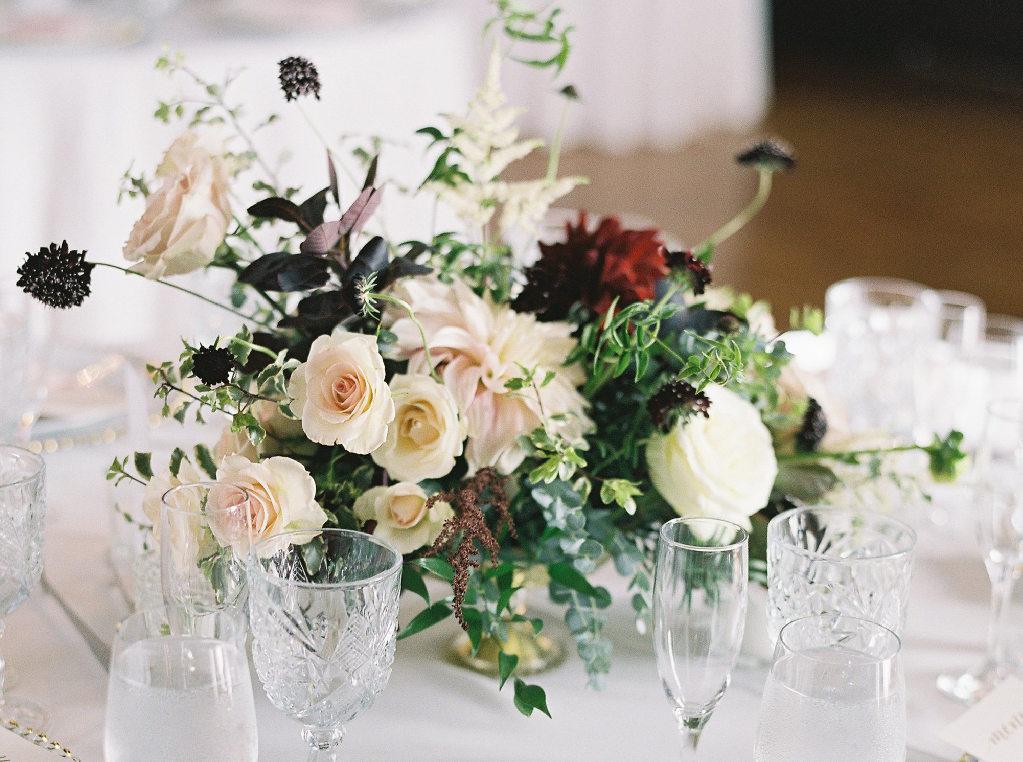 Garden-style reception centerpiece with roses and scabiosa