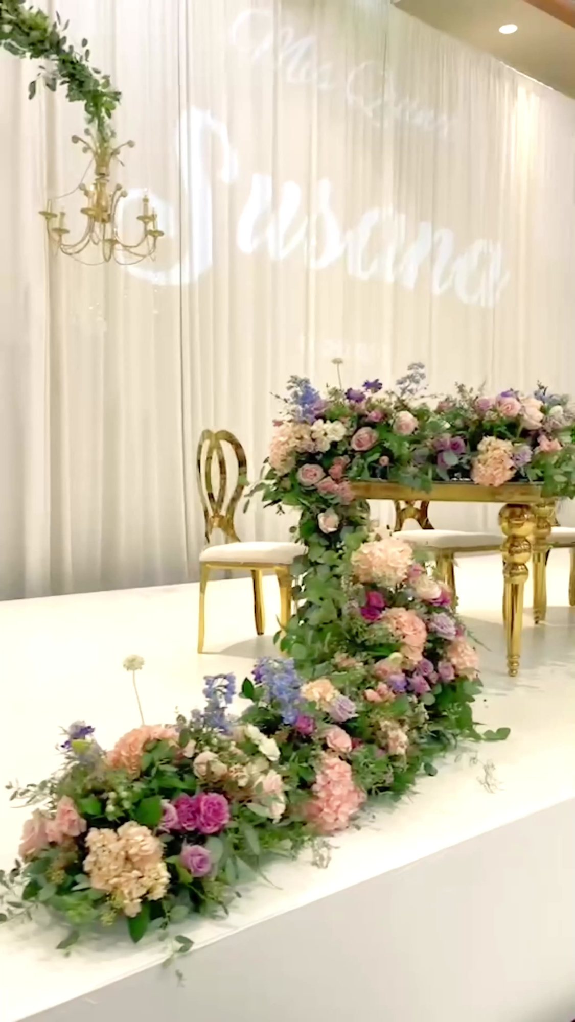 Floral event backdrop and installation with blush and green blooms