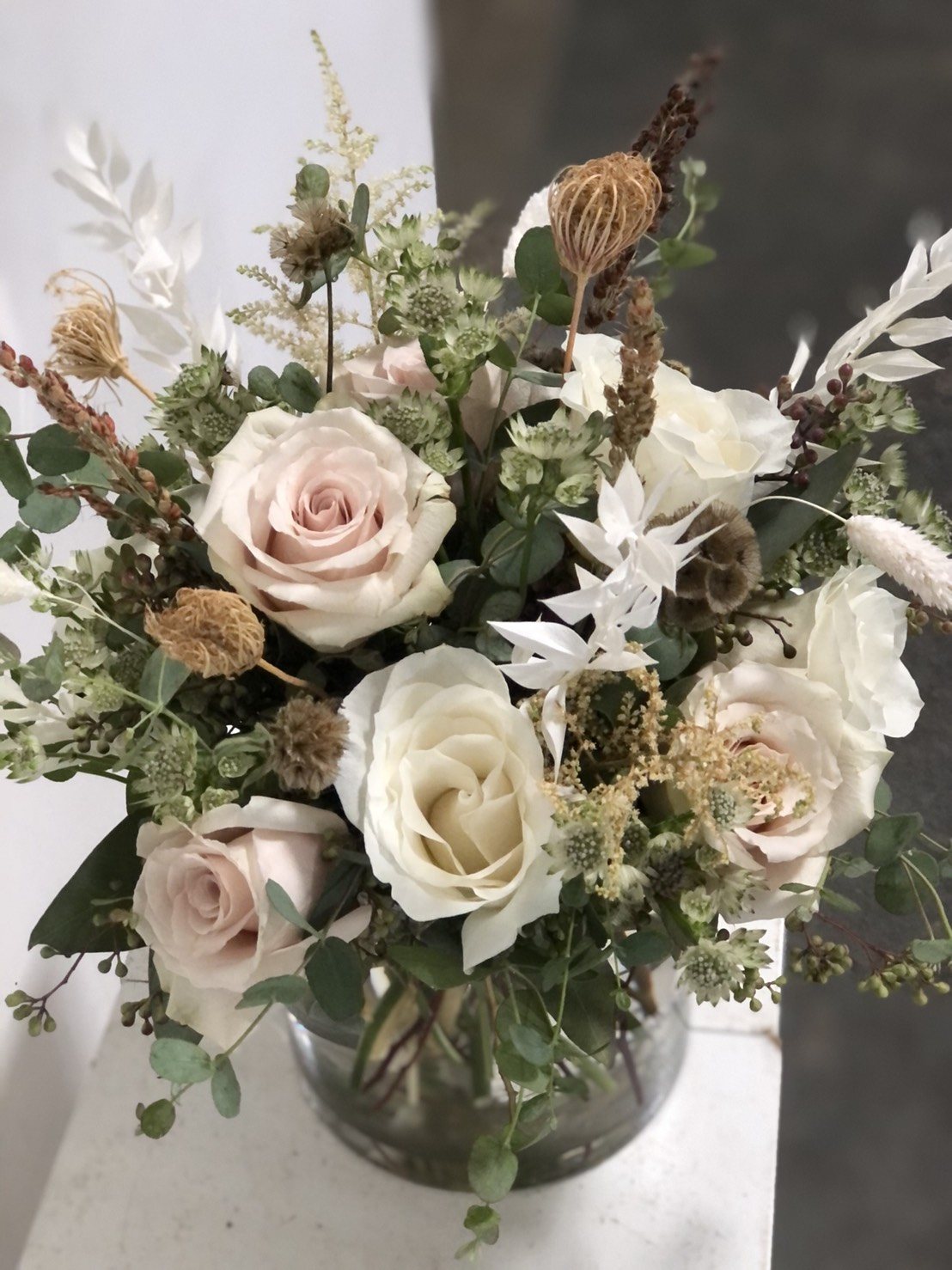 Classic pavé-style arrangement of blush and white roses